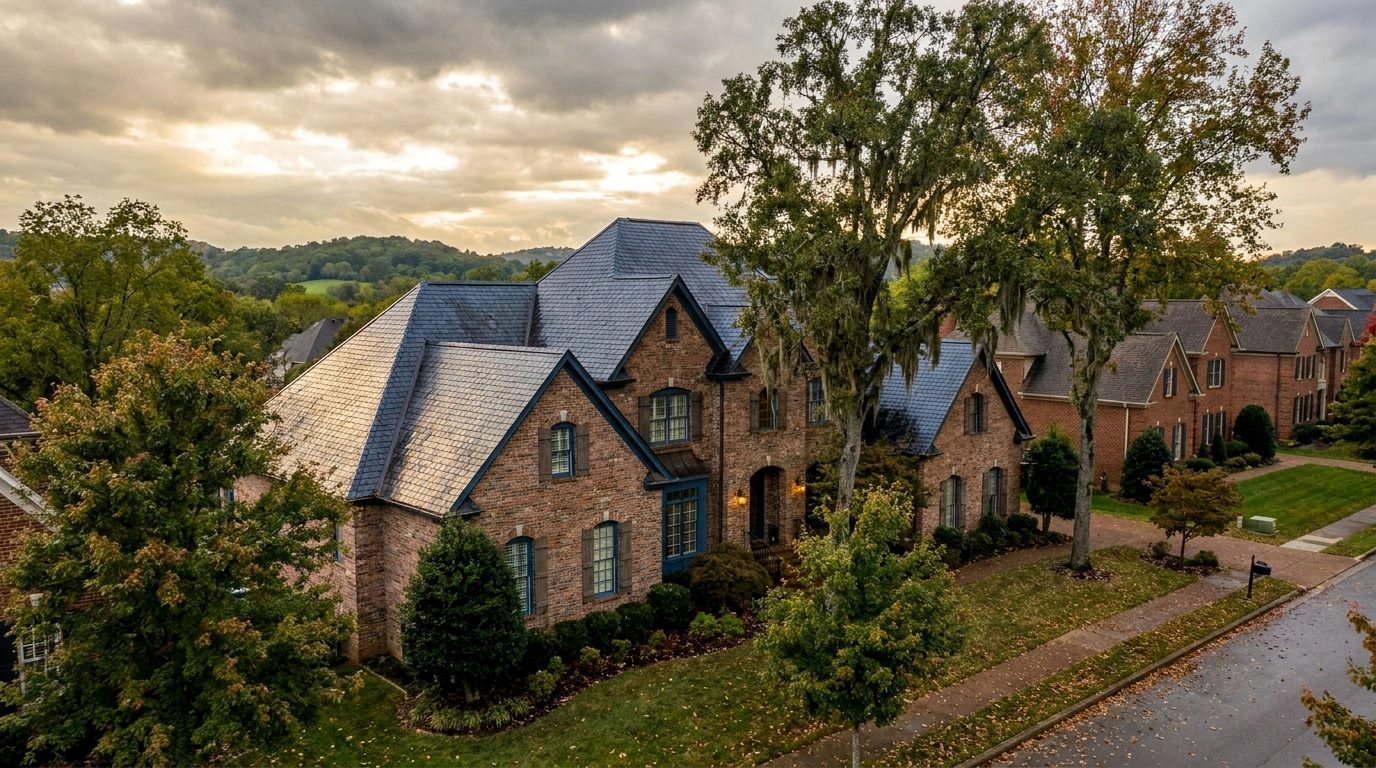 A large brick home with a steep multi-gable roof in Brentwood, Tennessee